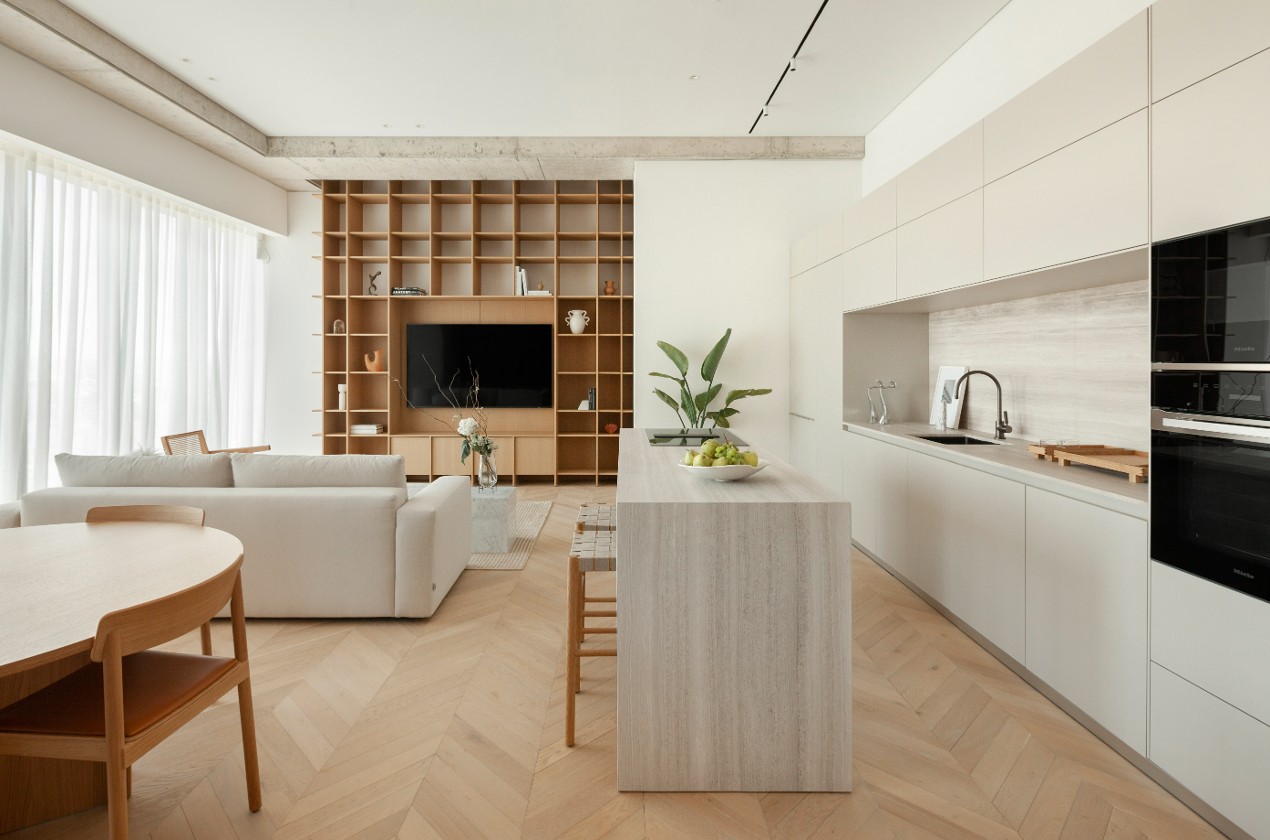 Marble kitchen island side view with oak floors