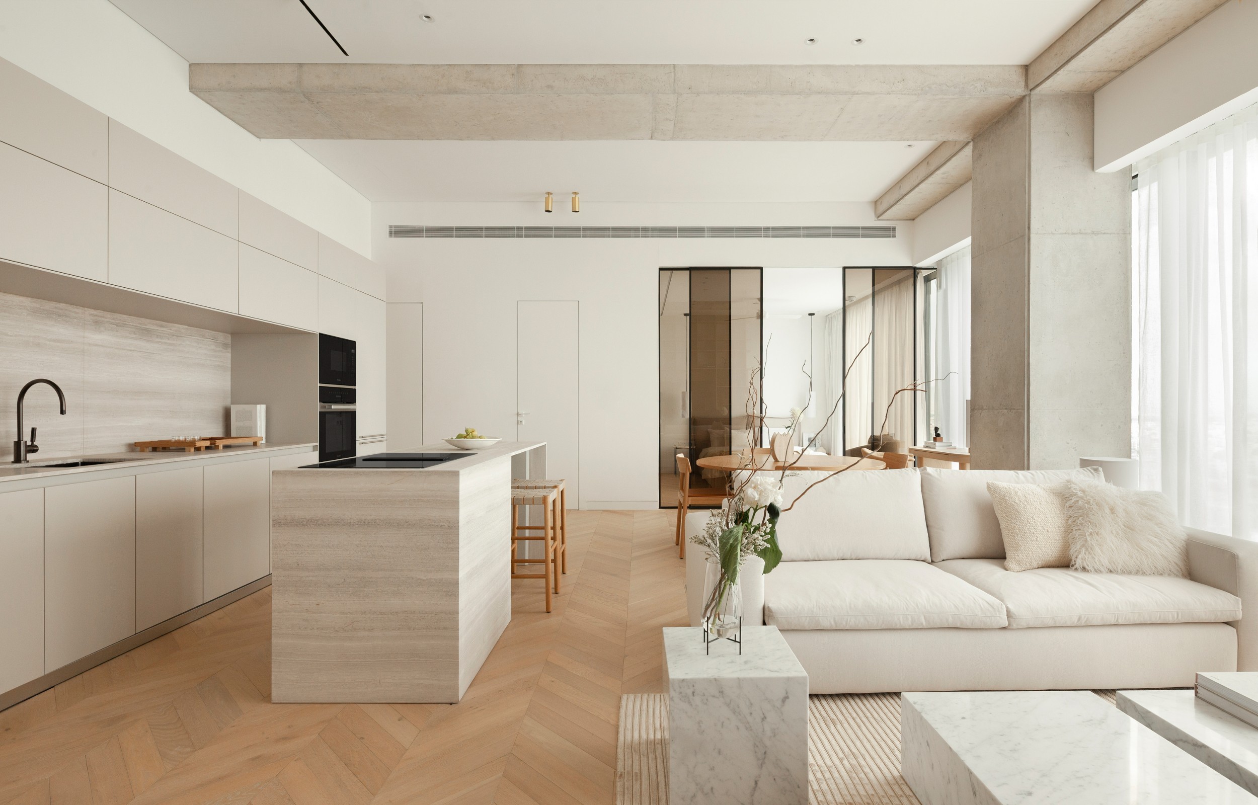 Marble kitchen and coffee tables complement natural oak floors