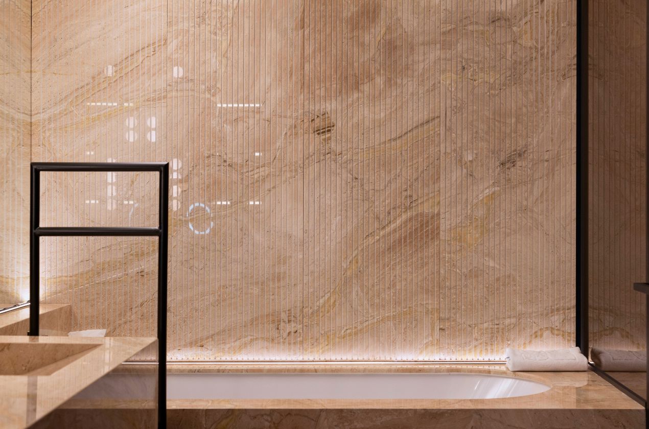 Daino reale marble bathroom walls Vertical ribbed detailing adds depth and texture to marble walls