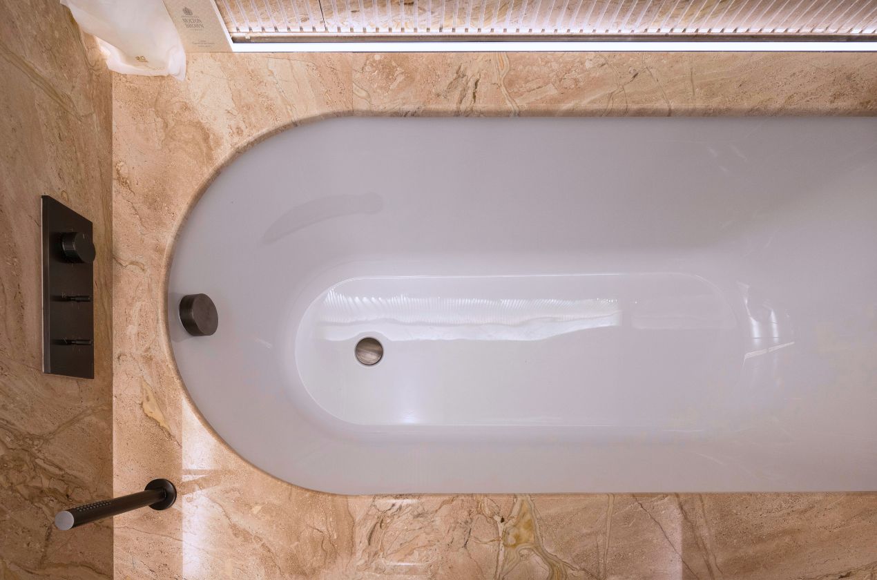 Daino reale marble bathtub The marble extends over the tub deck and apron