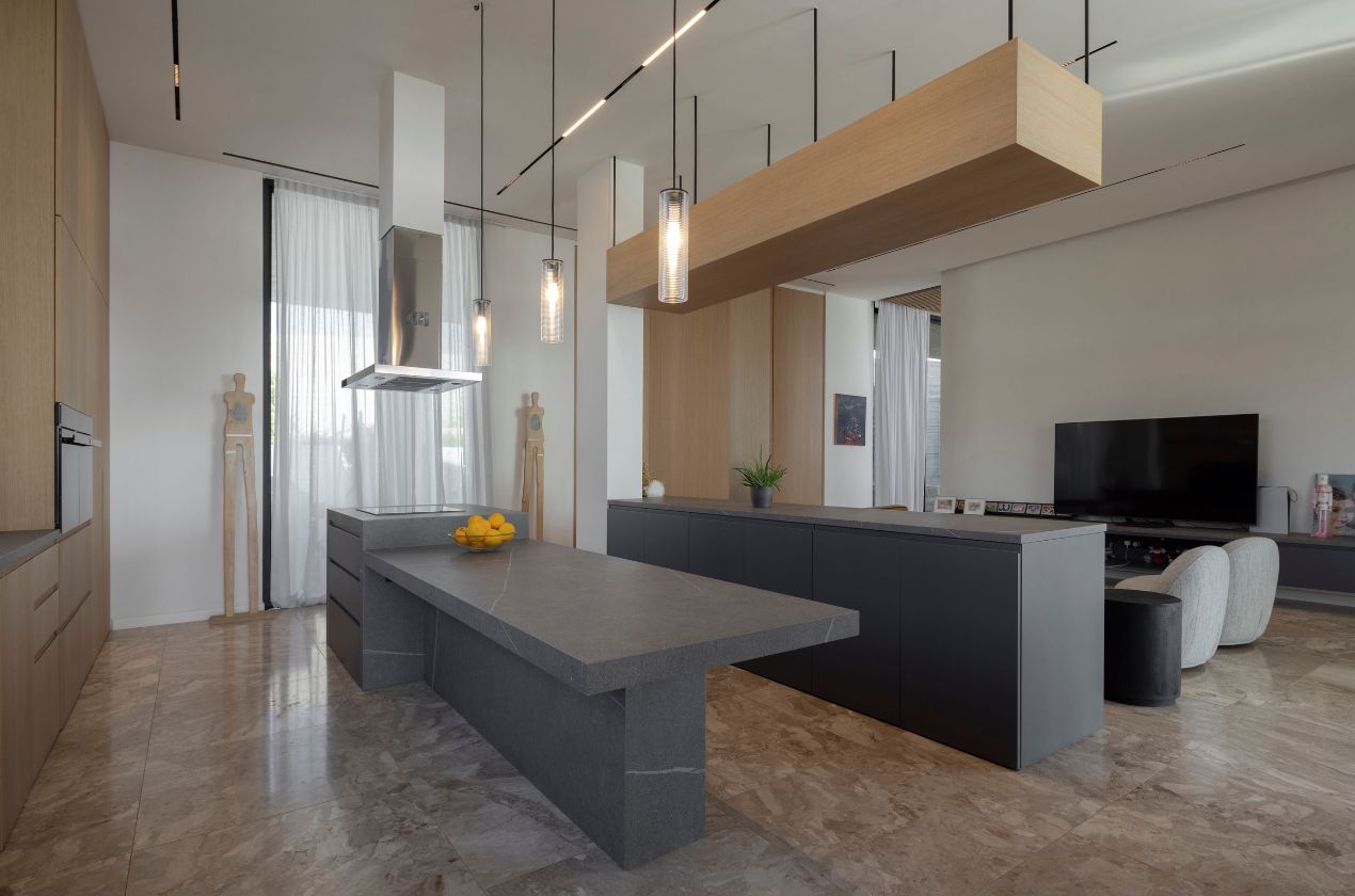 Senda MDi Kitchen Worktop Modern kitchen interior with a sleek Senda MDi kitchen Worktop in dark gray, featuring minimalist cabinetry, pendant lighting, and marble flooring in an open-concept living space.