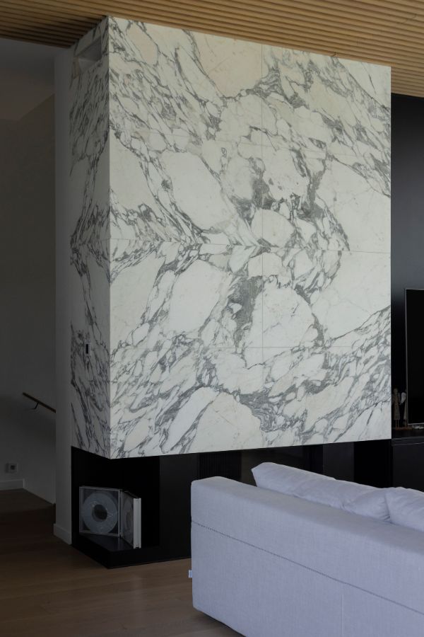 Arabescato marble bookmatched fireplace wall