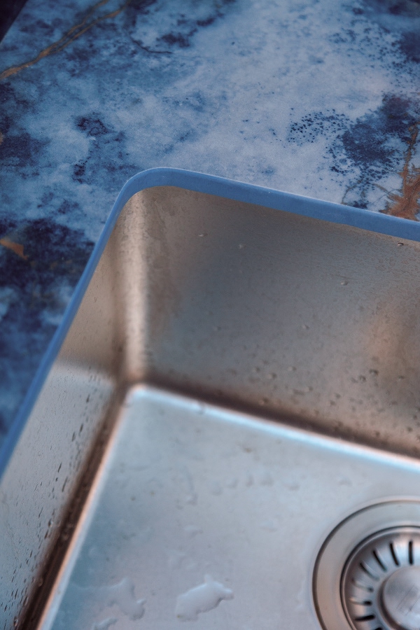deep blue onyx effect surface with washbasin detail